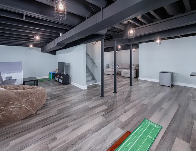 High-end basement finishing project by Five Stars Contracting in Somerville, MA, featuring modern flooring and lighting.
