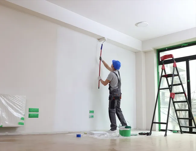 Expert painter performing interior wall painting for a residential home renovation in Somerville, MA.